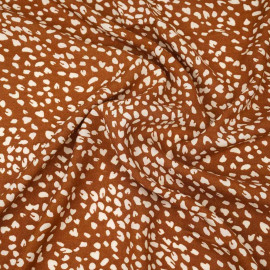 Tissu viscose rust à motif léopard écru
